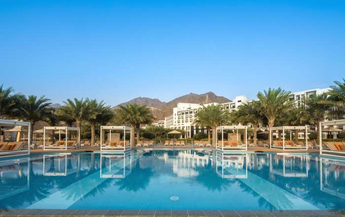 Relax in the imposing shadow of the Hajar Mountains