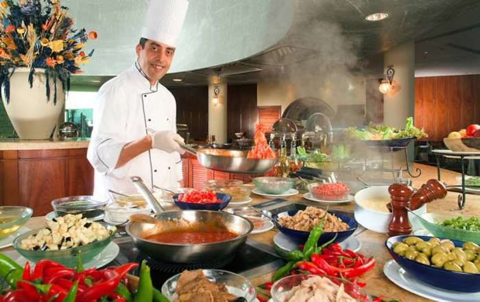 Chef cooking food at restaurant