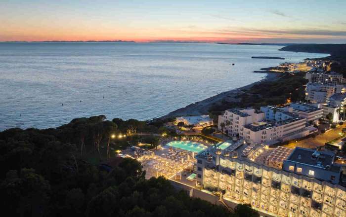 Aerial Shot of the Resort's Beachfront Location at Night