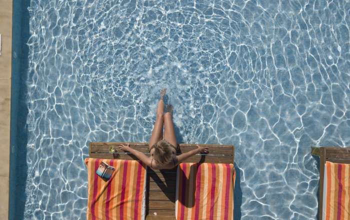 You May be Surrounded by Things to do, But you Can Still Catch Up on Some Reading Poolside.