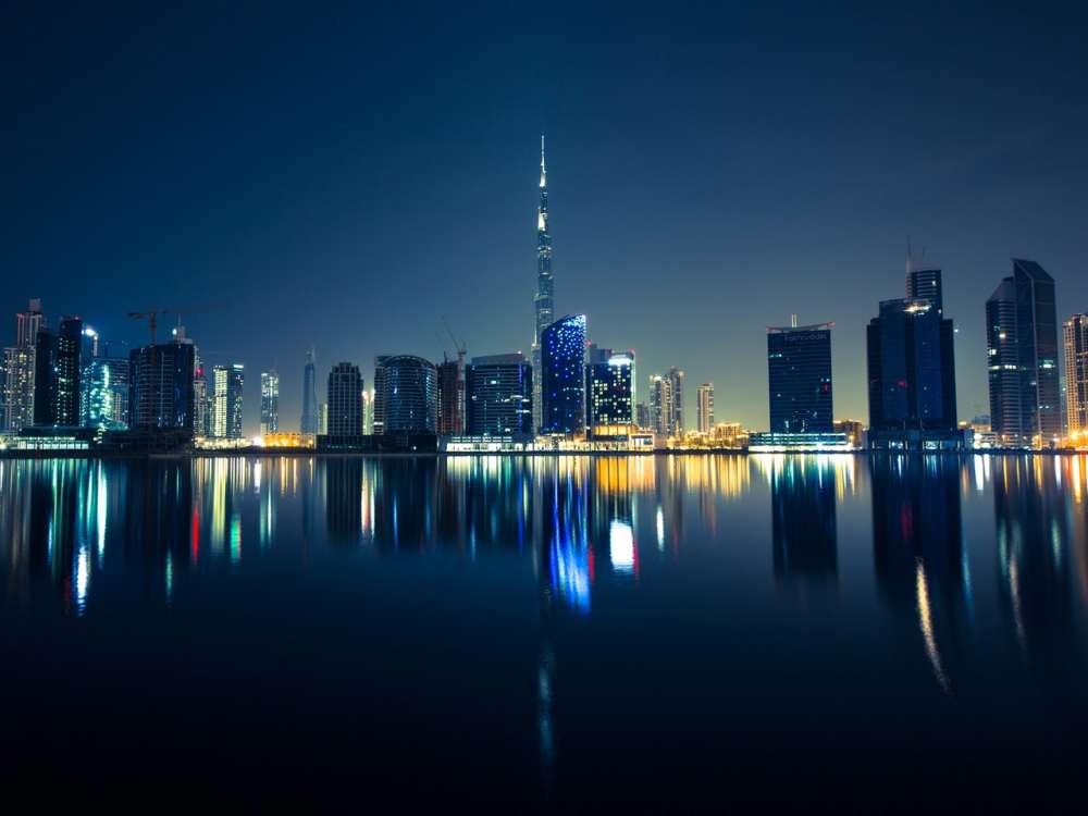 The Dubai skyline at night. The Burj Khalifa is in the centre of the image. 