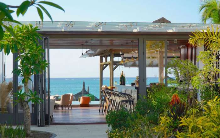 Grab a drink from the bar before relaxing at the poolside
